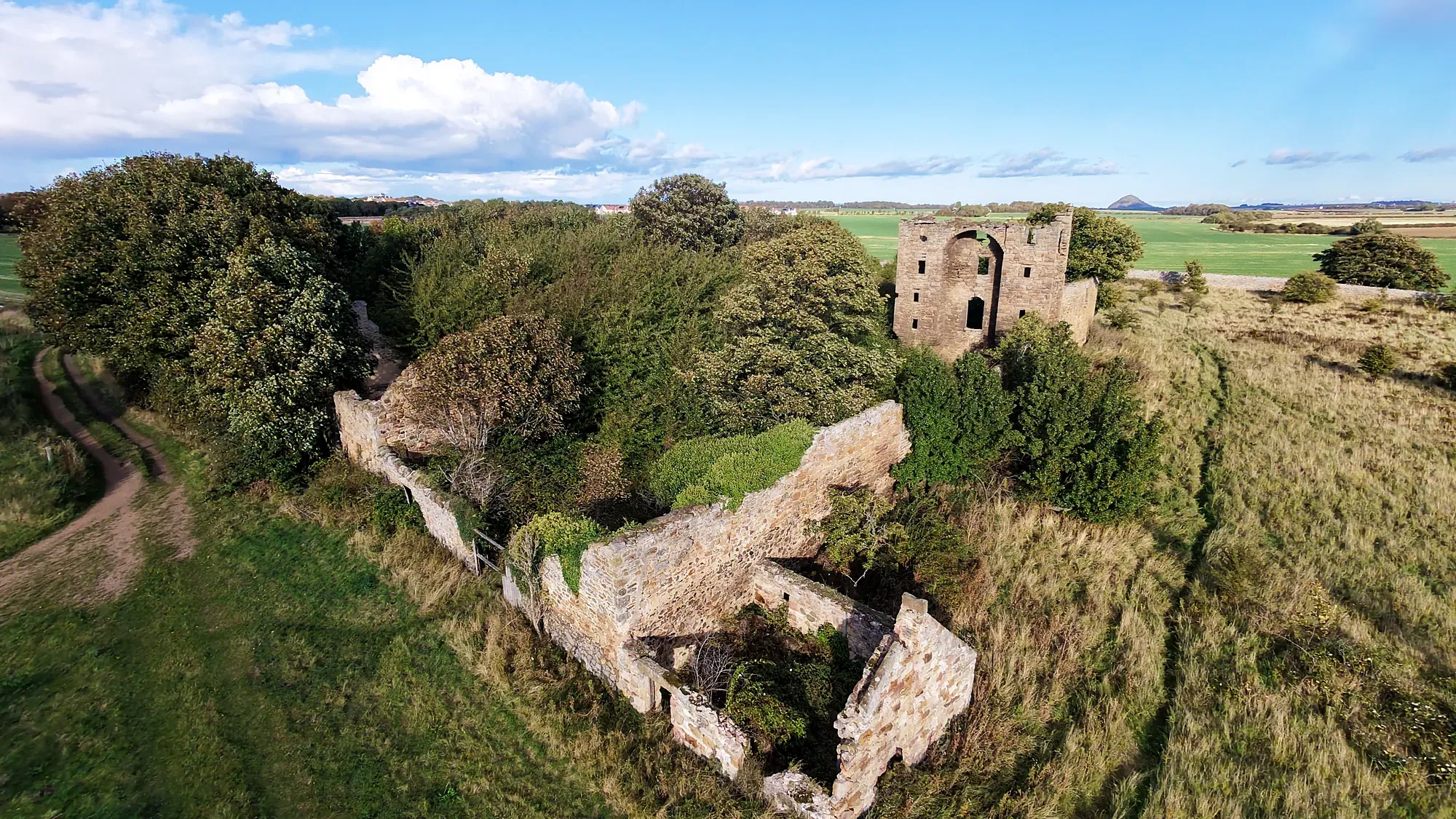 Saltcoats Castle ruins among fields from a drone