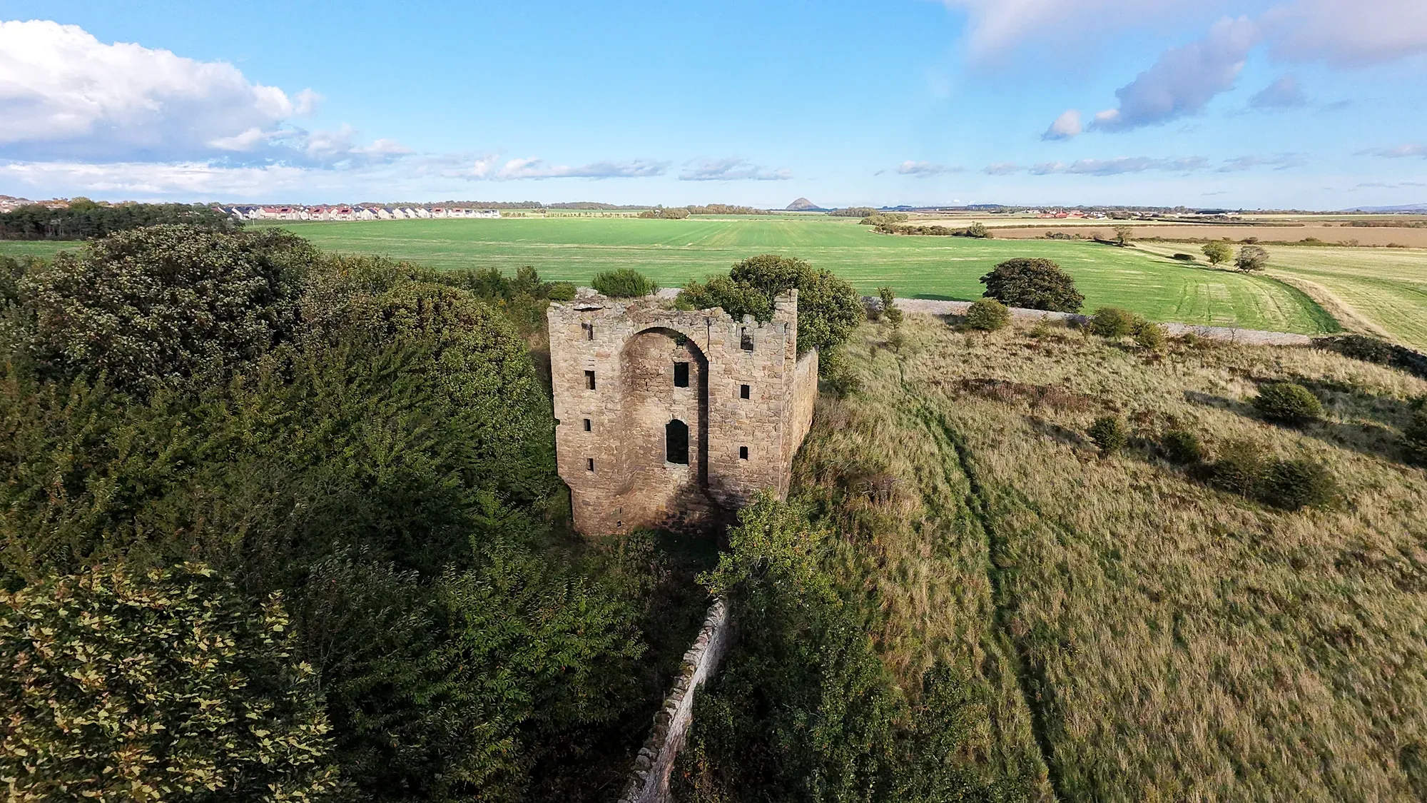 Saltcoats Castle tower surrounded by greenery